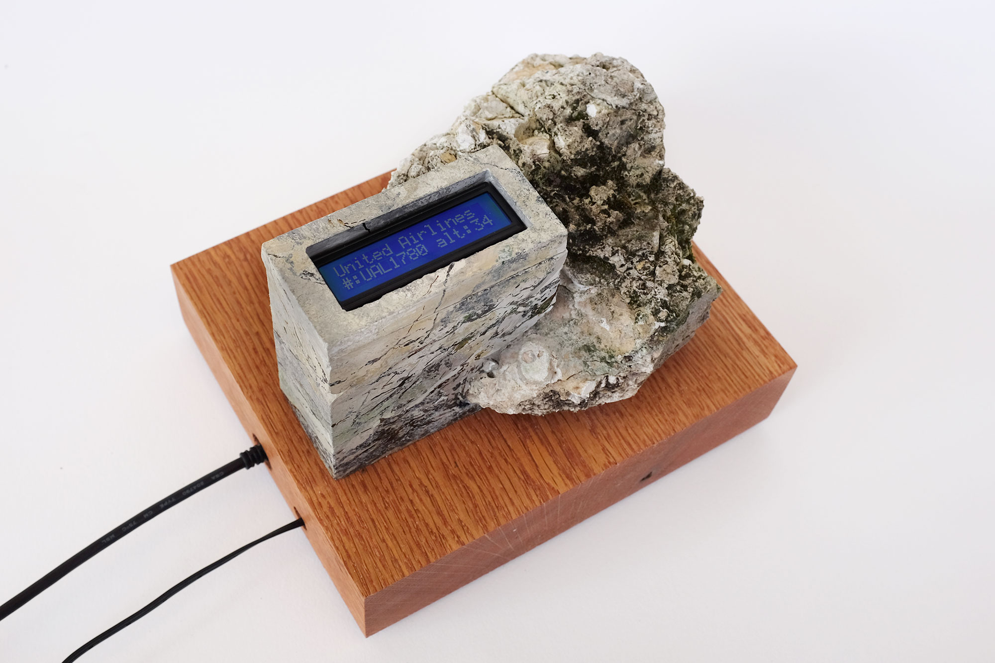 a piece of limestone, with attached screen that reads: united airlines #: UAL1780