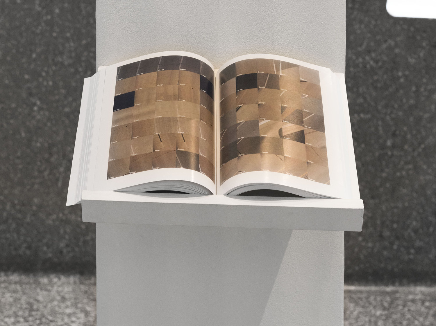 a book on a pedestal open to a bunch of images of roads